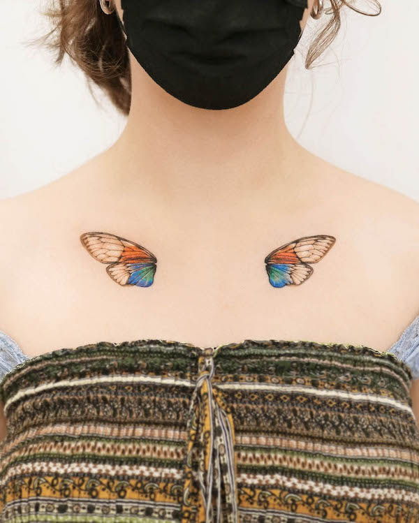 Symmetrical butterfly wings chest tattoo by @tattooist_yun