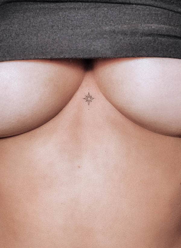 Tiny star symbol tattoo between boob by @mayoanj