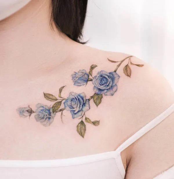 Vintage blue rose collarbone tattoo