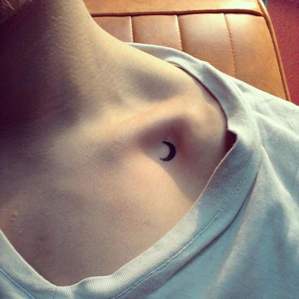 A tiny crescent moon on clavicle tattoo