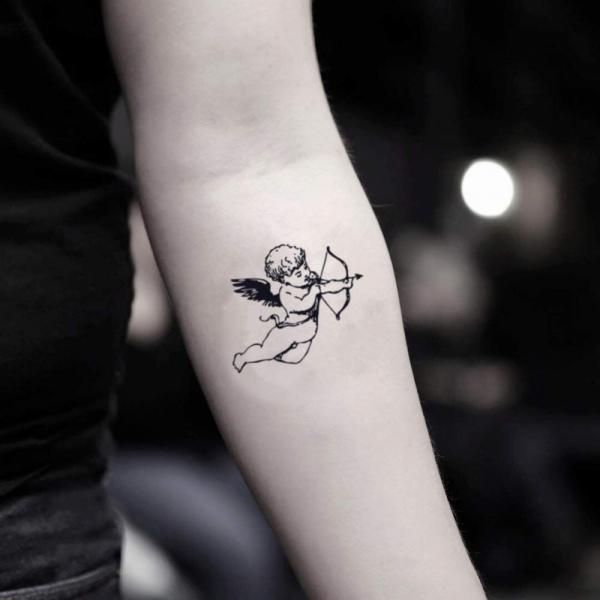 Small cupid tattoo on forearm