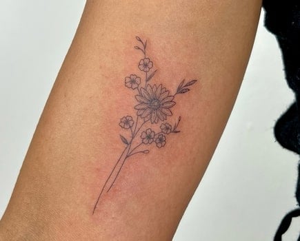 forearm daisy tattoo design