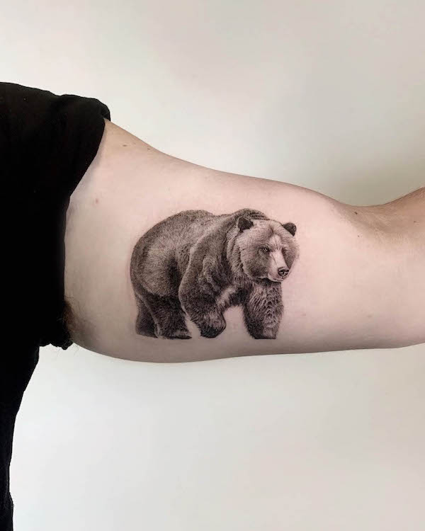 Realism grizzly bear bicep tattoo by @kerem.g.tatt