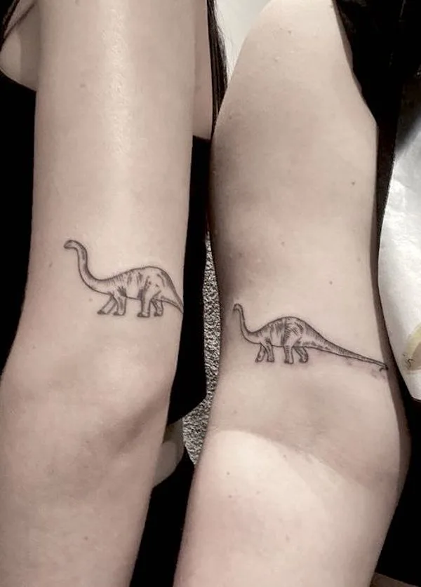 Matching dinosaur tattoos for sisters by @vanessamaypowell