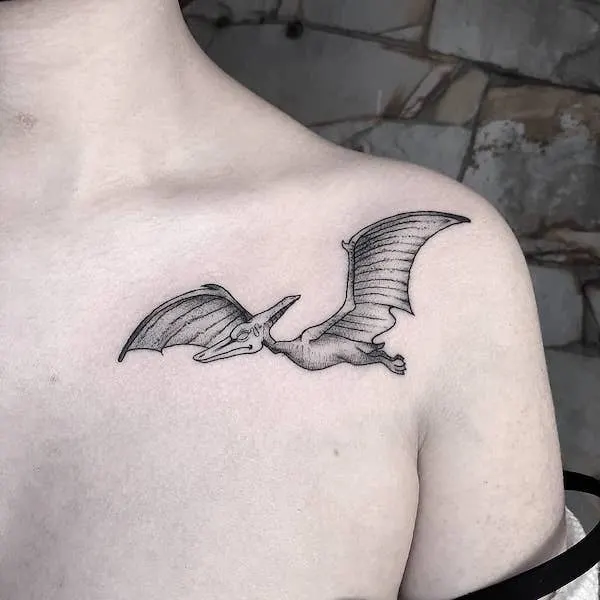 Black and grey pterodactyl shoulder tattoo by @miguel.truman