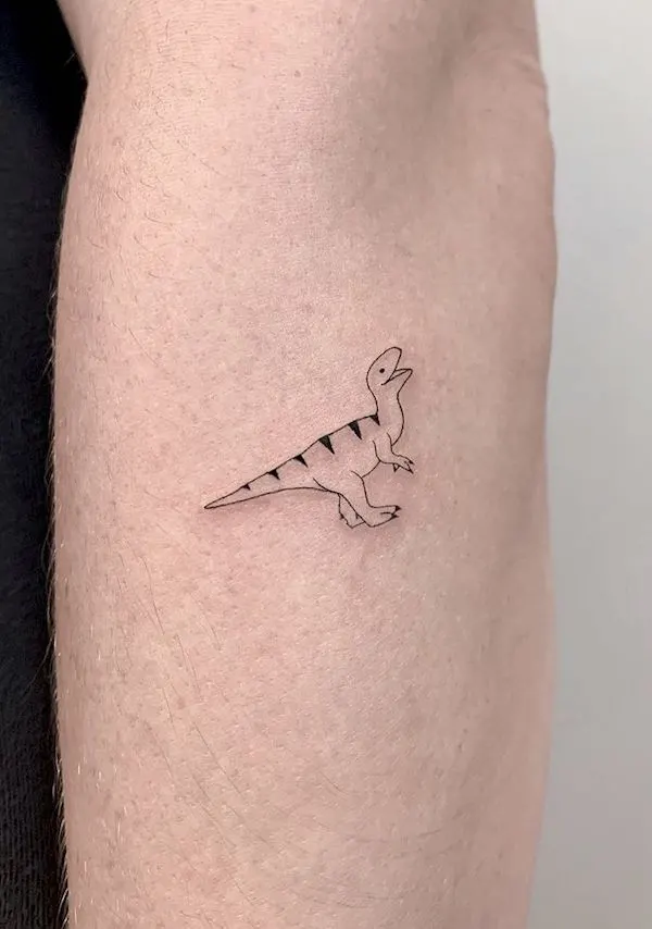 Tiny dinosaur forearm tattoo by @memoryinscriptions