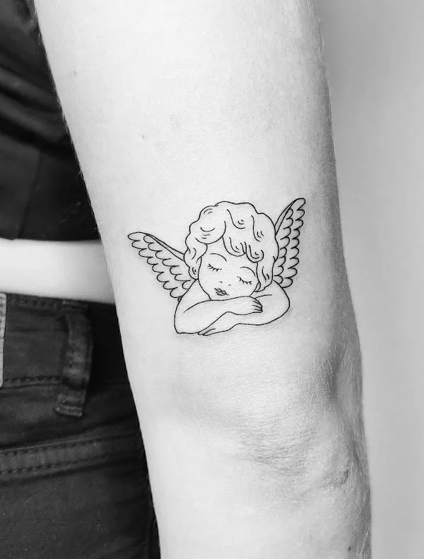 Cupid love tattoo above elbow by @tattoosbyina