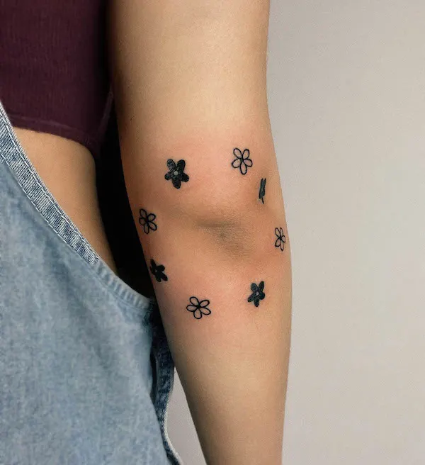 Small flowers elbow tattoo by @bethkweedaytattoo