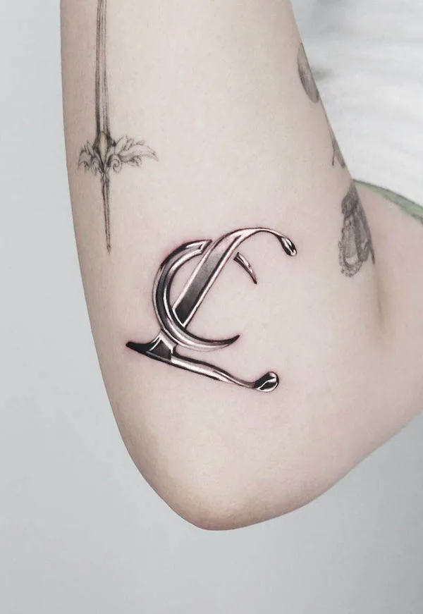 Initials elbow tattoo by @jooa_tattoo