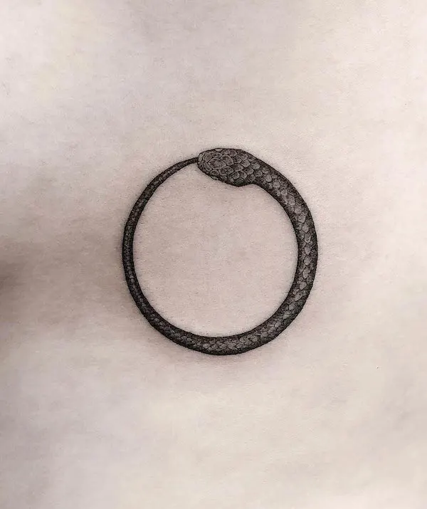 Simple small ouroboros tattoo by @annarehtattoo