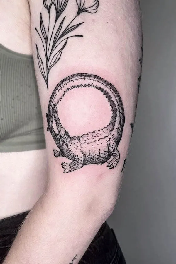 Crocodile ouroboros arm tattoo by @gardenpartytattoo