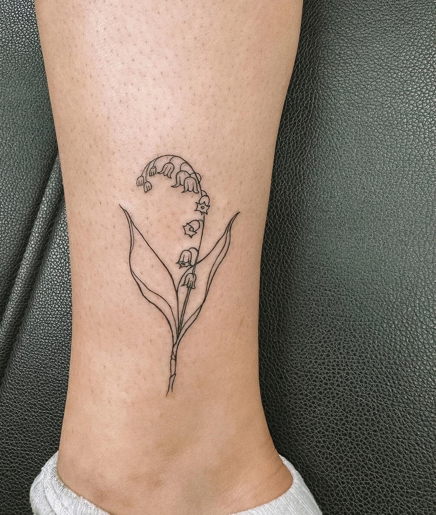 Lily flower tattoo located on the ankle