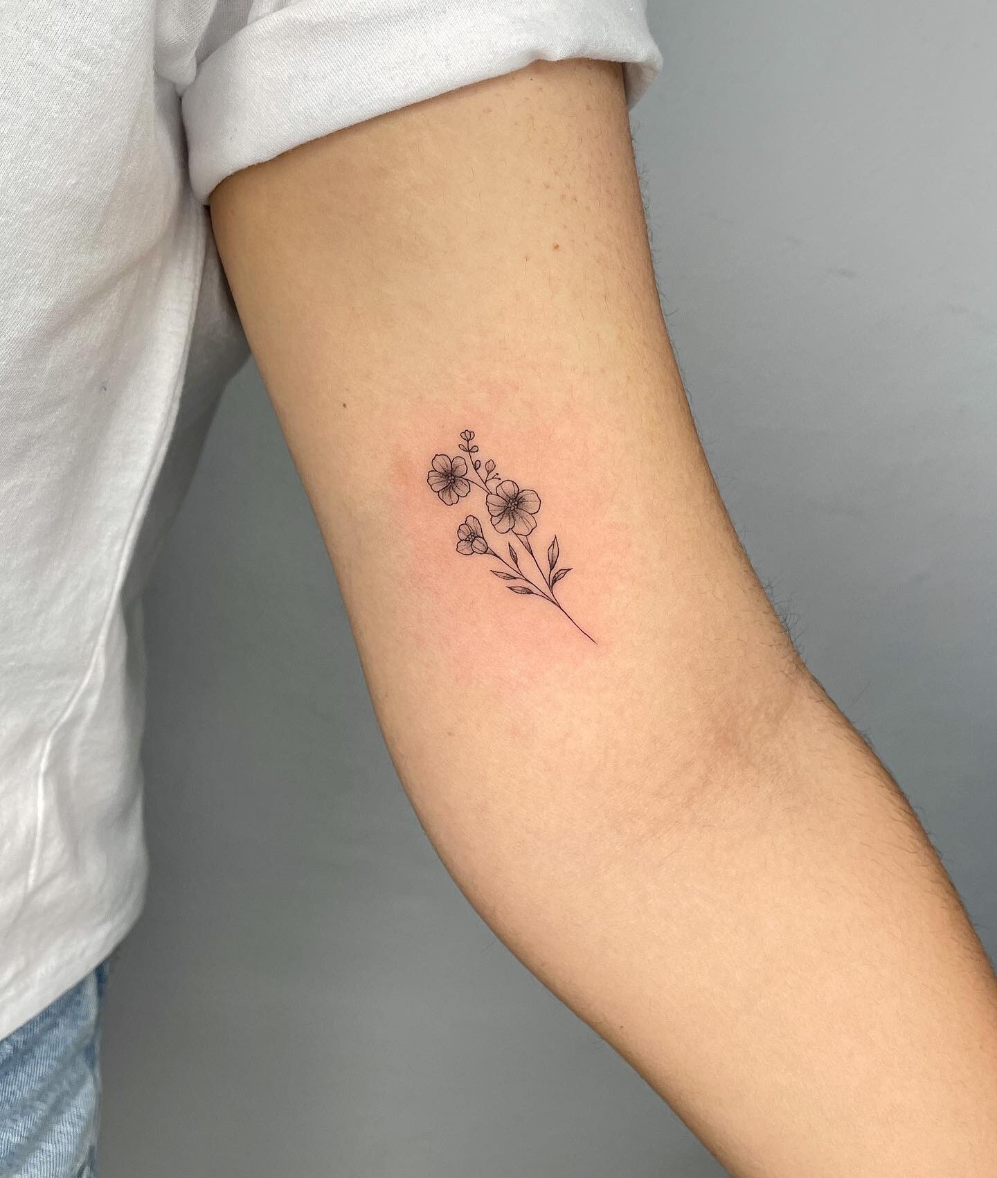 Flowers tattooed on the inner arm